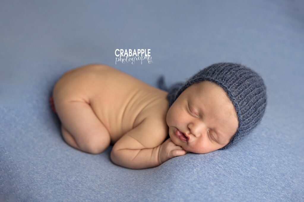 classic blue newborn photos studio newborn session using simple blue backdrop for a classic look