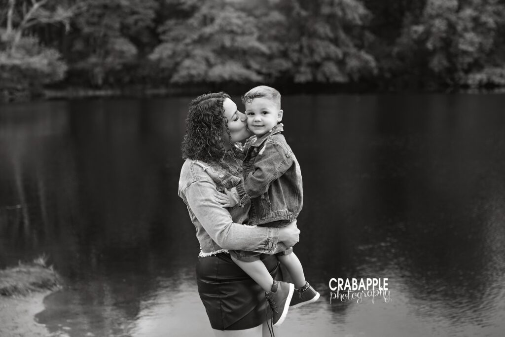 playful mom lifting 3 year old son outdoors during child photography session by a North Shore family photographer 
