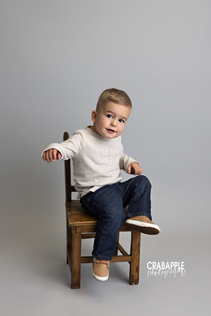candid toddler sitting on chair studio
