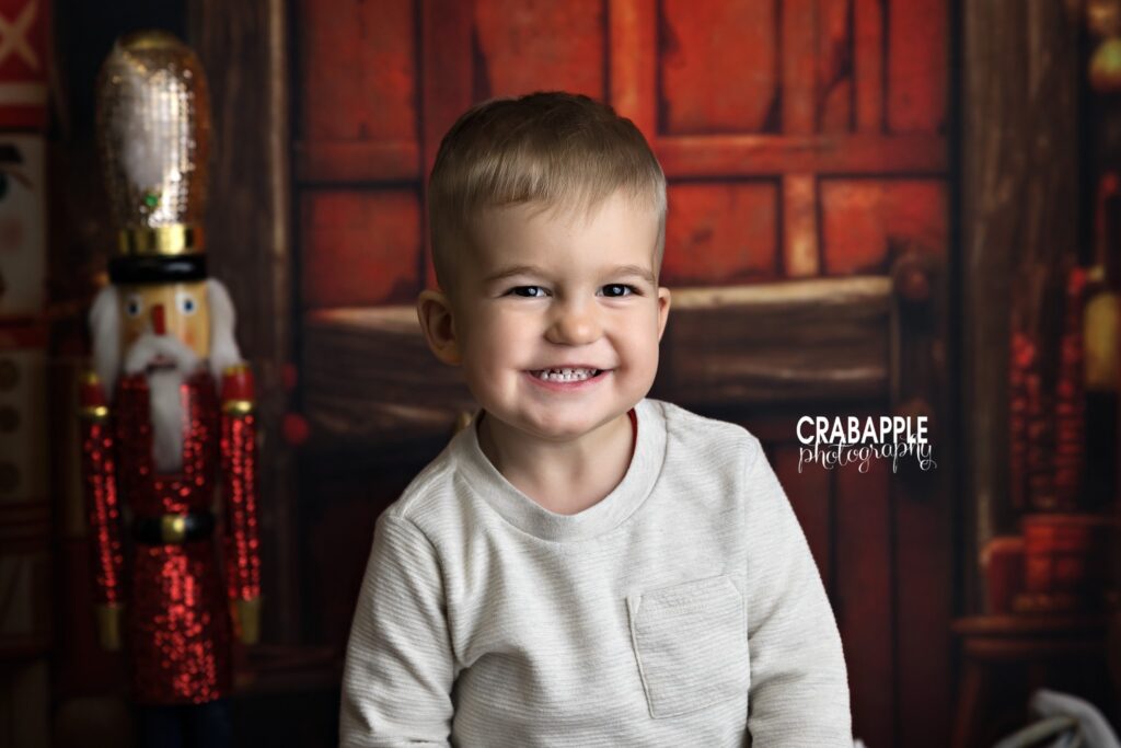 Close up of toddler smiling on Christmas set design