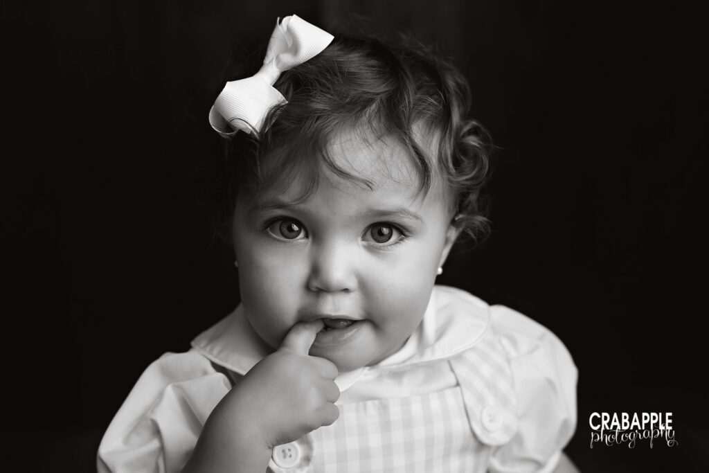 black and white portrait of baby girl close up during baby milestone photos
