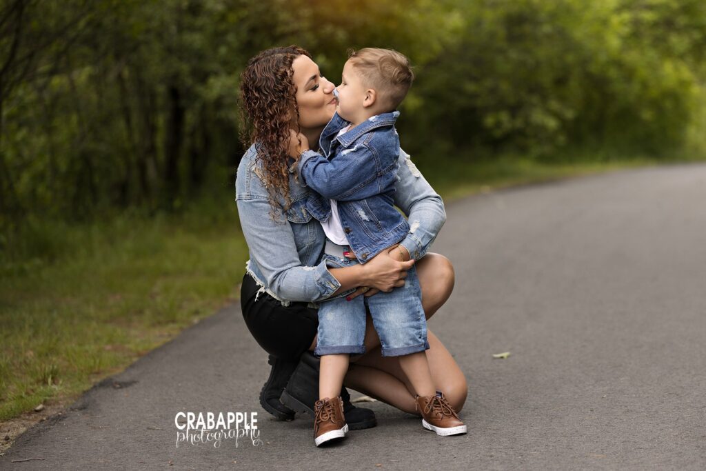 mother kissing her 3 year old son during outdoor child photography session
