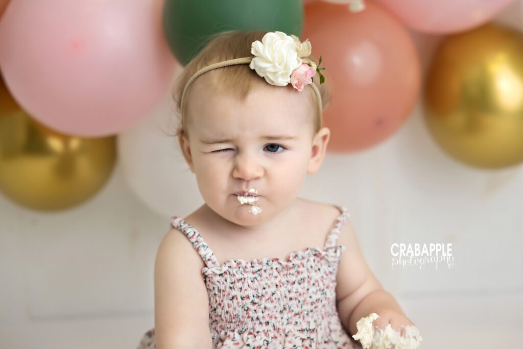 Funny cake smash moment with baby winking