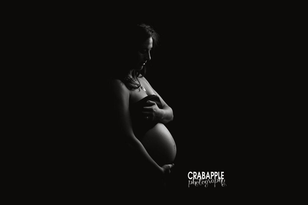 Artistic black and white nude maternity portrait with halo lighting
