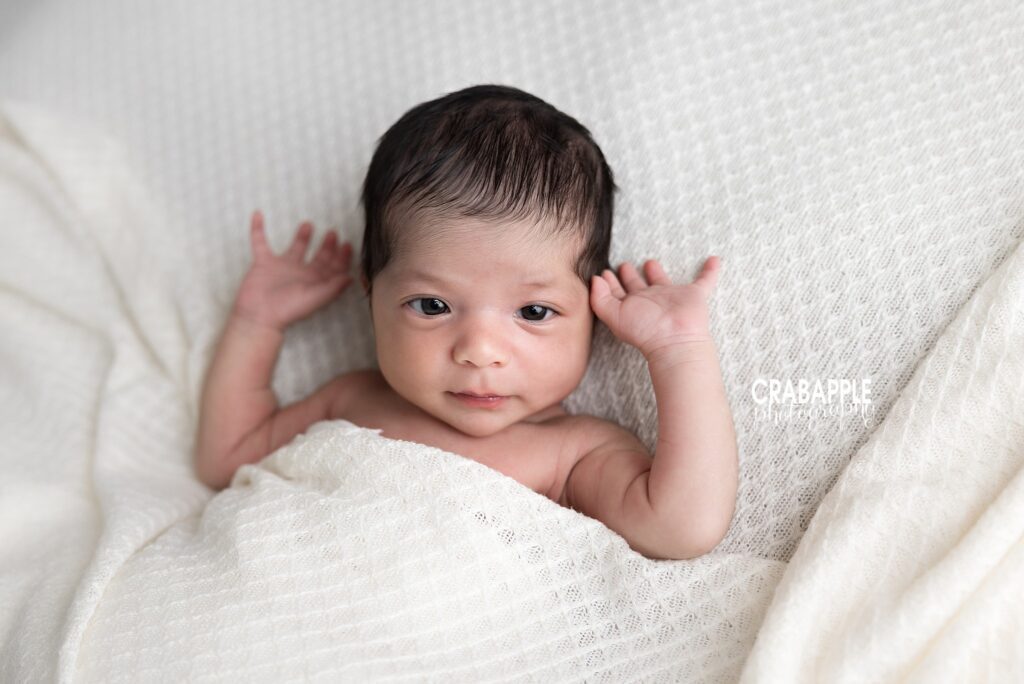 Awake Baby Girl Portrait Awake newborn baby stretching arms during studio session