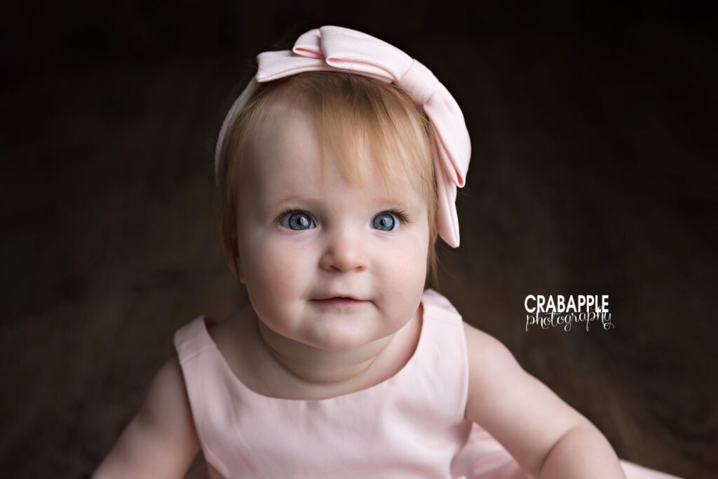 Close up portrait of one year old baby girl during first birthday session
