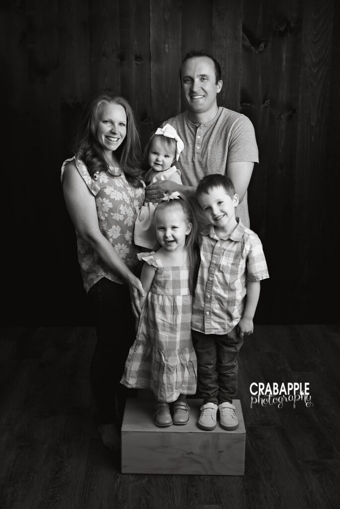 Black and white family portrait with parents and three children
