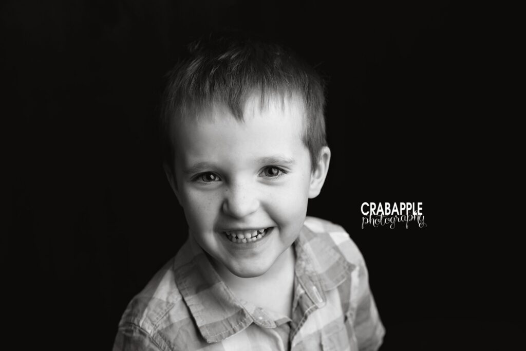 Black and white close up portrait of older brother smiling
