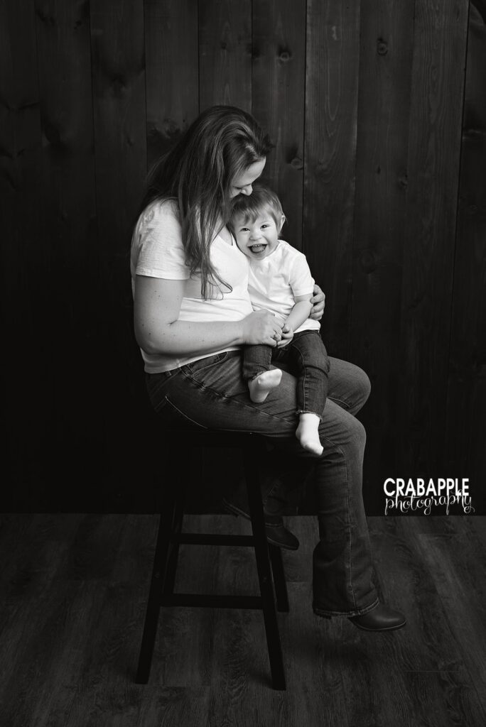 Black and white style mother and daughter portrait seated on stool
