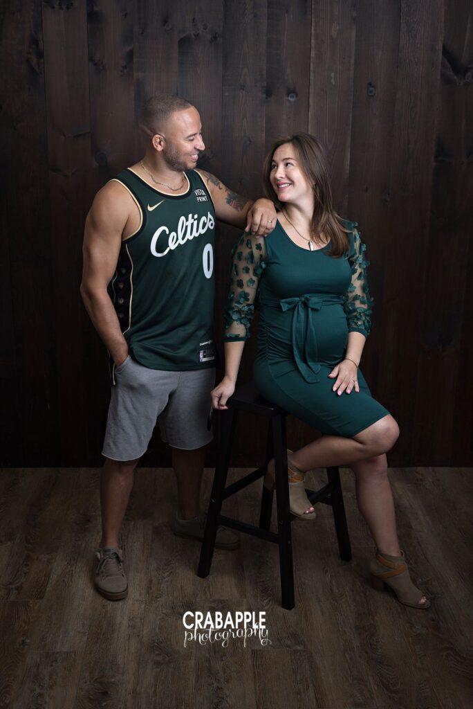 Boston Celtics inspired maternity portrait with green dress and basketball jersey

