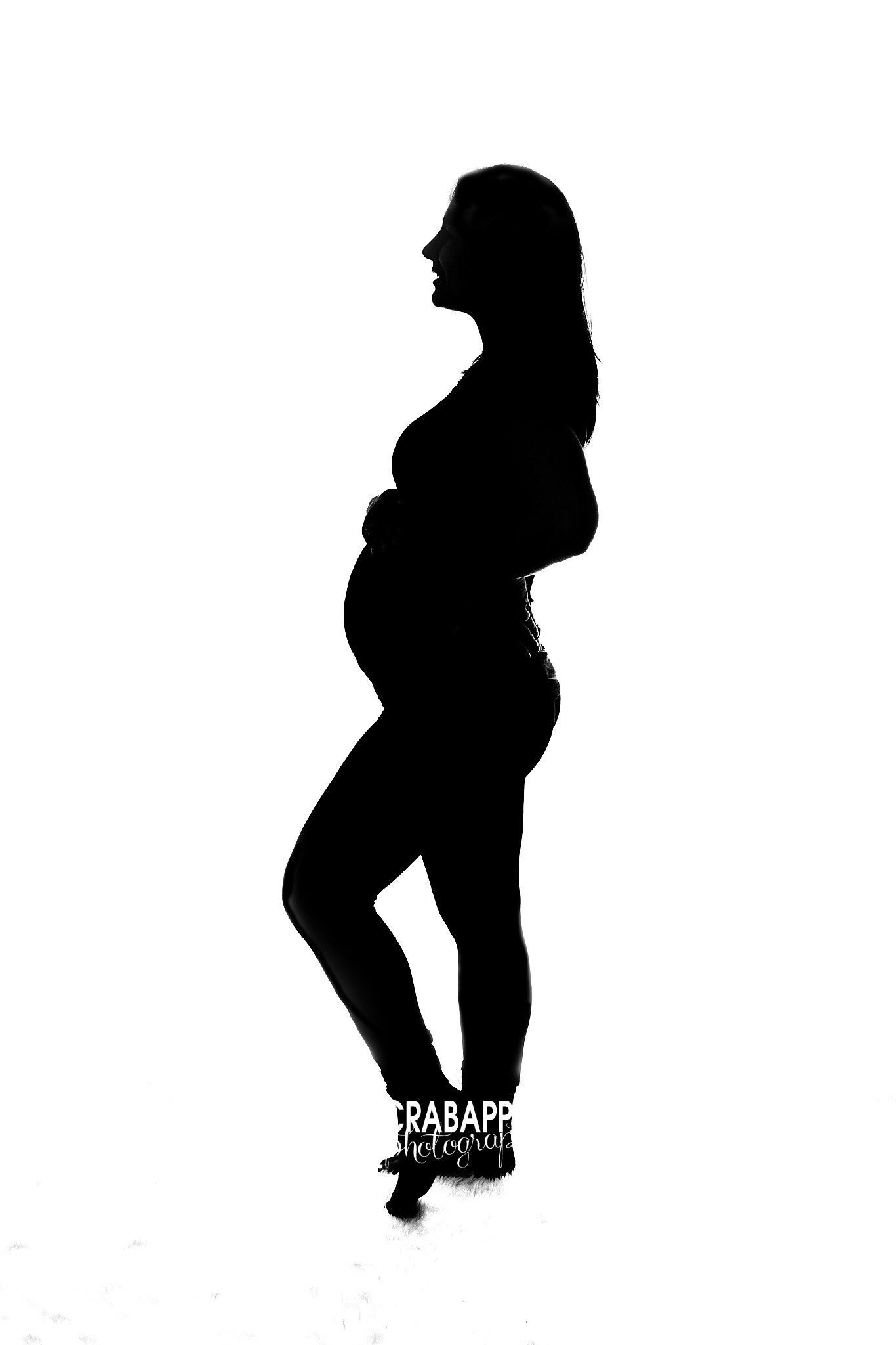 Silhouette maternity portrait of expecting mother in studio near Burlington MA
