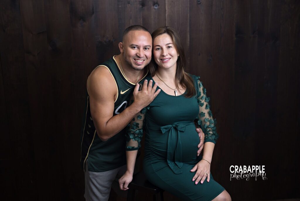 Couple posing together in Celtics inspired maternity photography session
