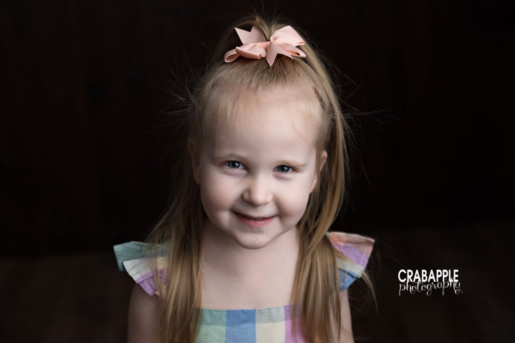 Close up color portrait of older sister smiling during family session
