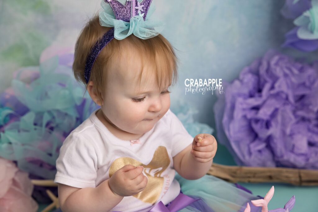 Candid photo mermaid themed cake smash setup with pastel decorations
