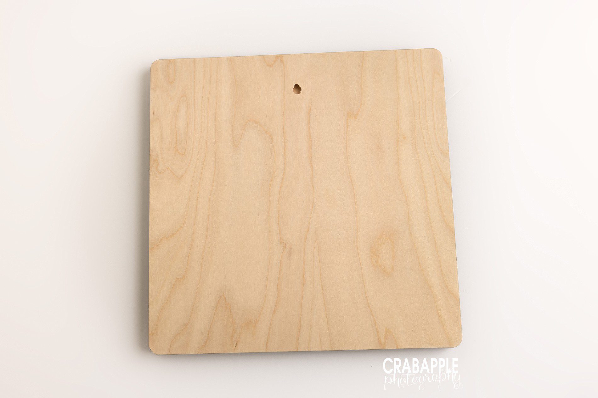 Back of 14x14 luxe wood mounted wall art showing built in keyhole hanger on birch wood backing
