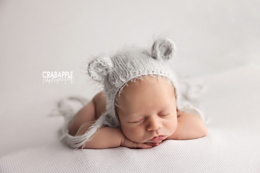 sleeping newborn baby boy wearing soft knit bear ear hat
