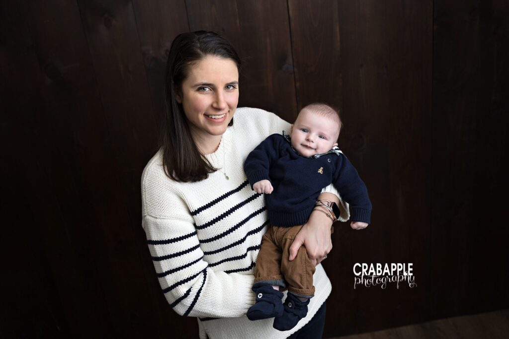 Mom holding smiling baby boy during timeless 3 month baby photos in Andover MA
