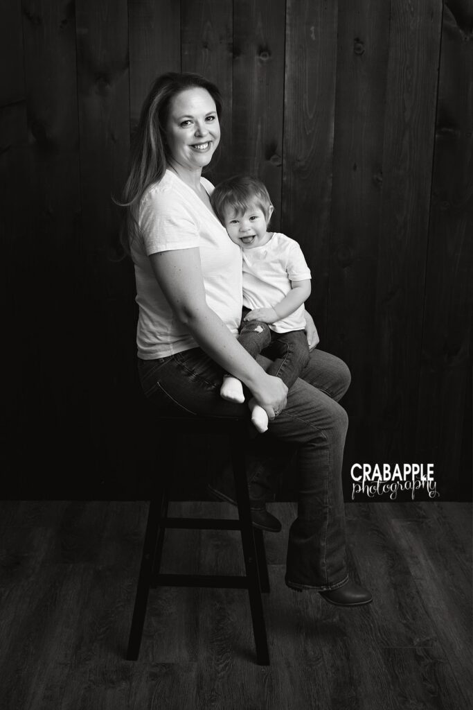 Mother and daughter smiling together during toddler photography session
