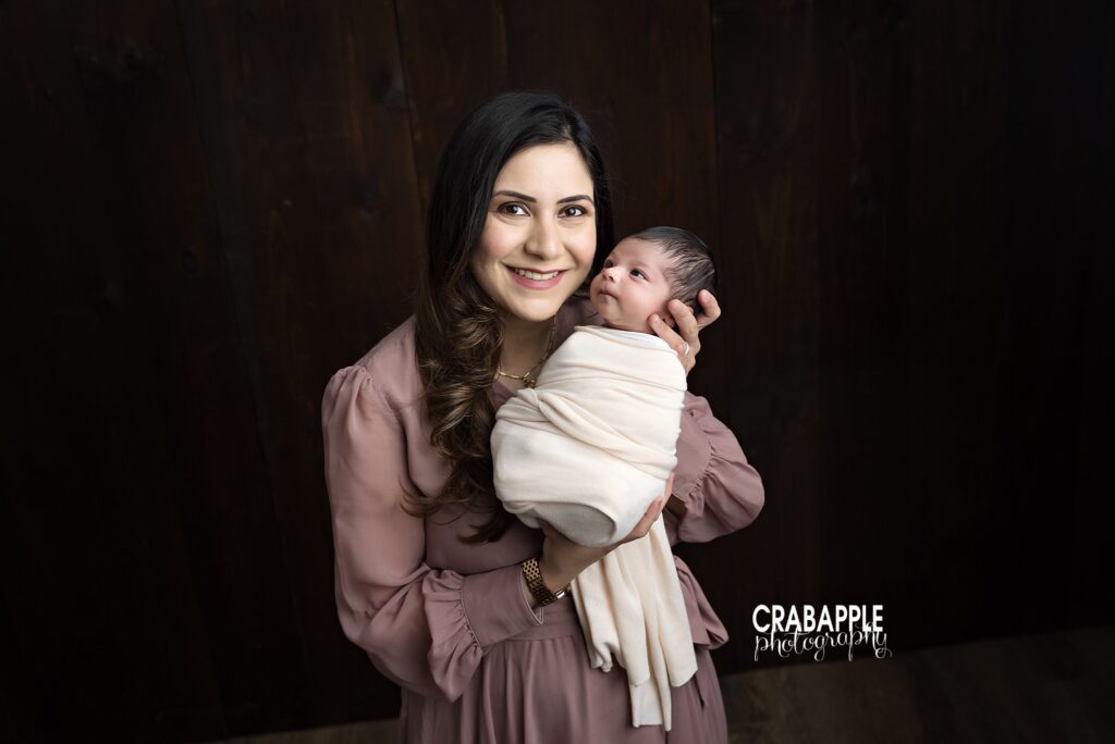 Mom Holding Baby Girl Mom holding newborn baby girl during studio newborn session in Andover MA