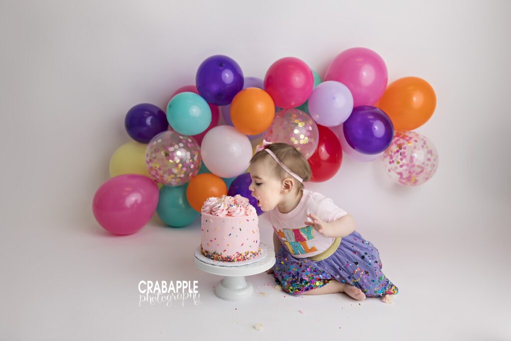 Cake Smash One year old covered in frosting during cake smash session