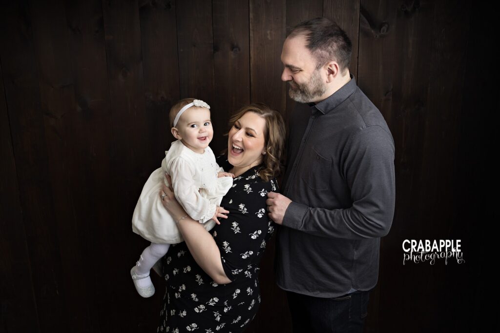 First Birthday Family Photo Parents holding their one year old daughter during family portrait session