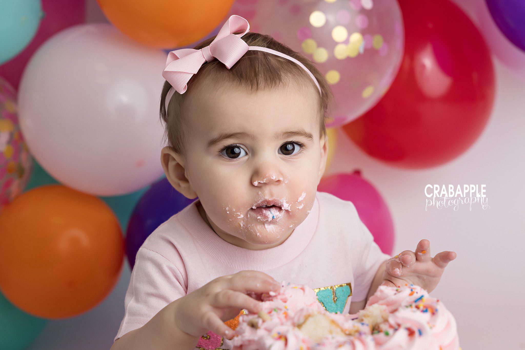 Frosting Hands Baby girl eating cake with frosting-covered hands