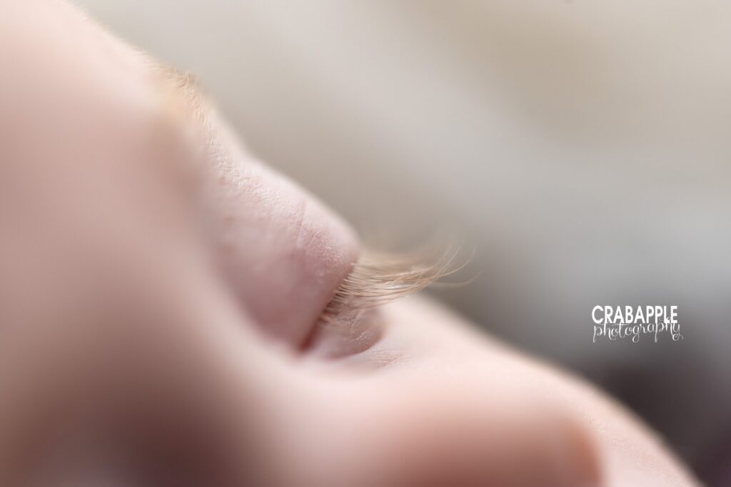 Close-up photograph of baby girl's eyelashes during milestone session

