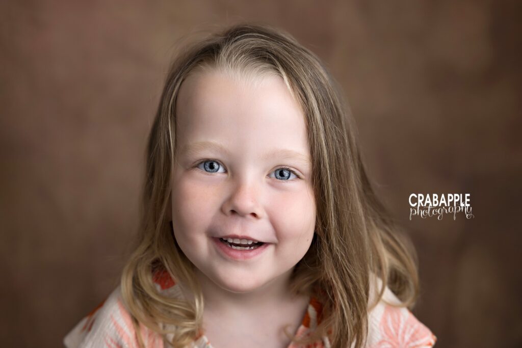 Portrait of four year old big sister in photography studio
