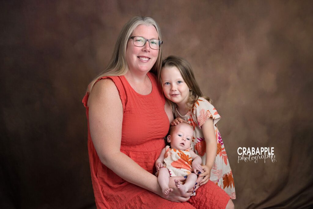 Mother with her two daughters during a three month milestone session
