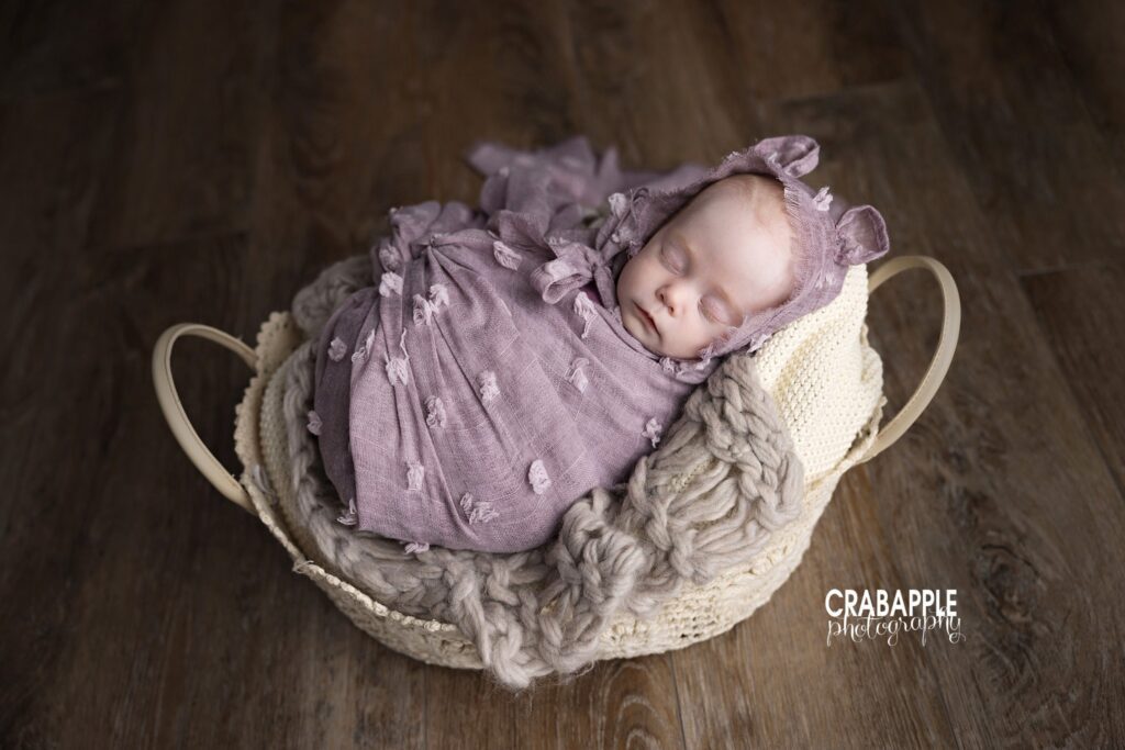 Three month old baby girl sleeping in decorative basket

