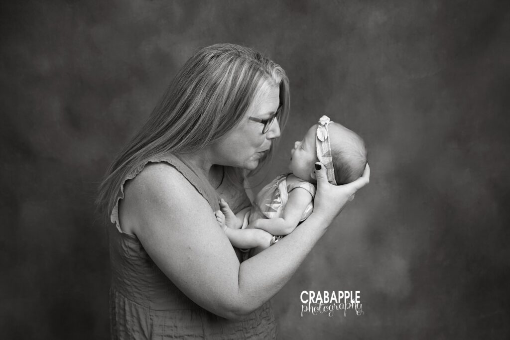 Black and white mommy and me portrait with mother holding her three month old daughter
