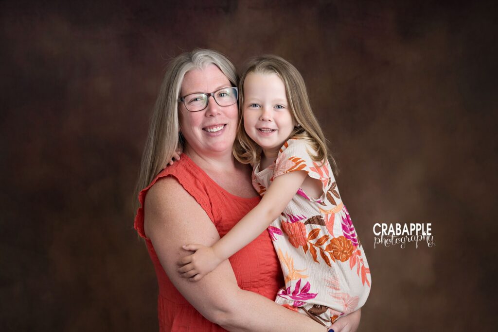 Mother and older daughter portrait during baby milestone session
