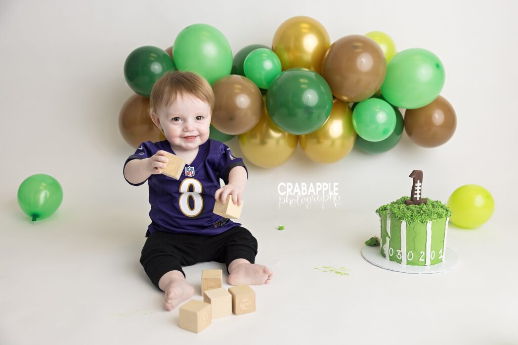 Football themed cake smash session for baby boy first birthday photos in Massachusetts photography studio