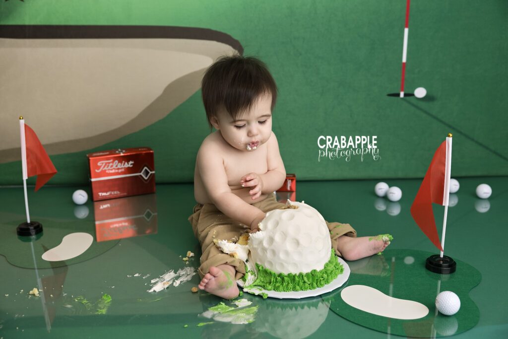 Baby boy milestone portrait with golf inspired birthday theme and custom first birthday photography setup