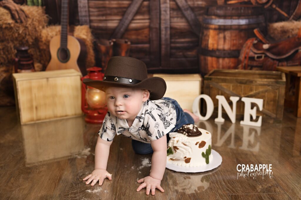 Western rodeo themed cake smash session featuring rustic first birthday setup for baby boy in Massachusetts studio