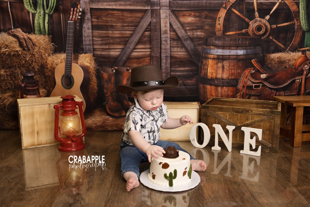 One year milestone photos featuring western birthday theme and rodeo inspired cake smash setup