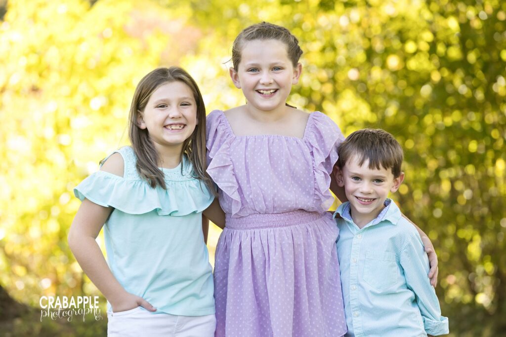 Three siblings standing together during outdoor fall family photos in Acton MA
