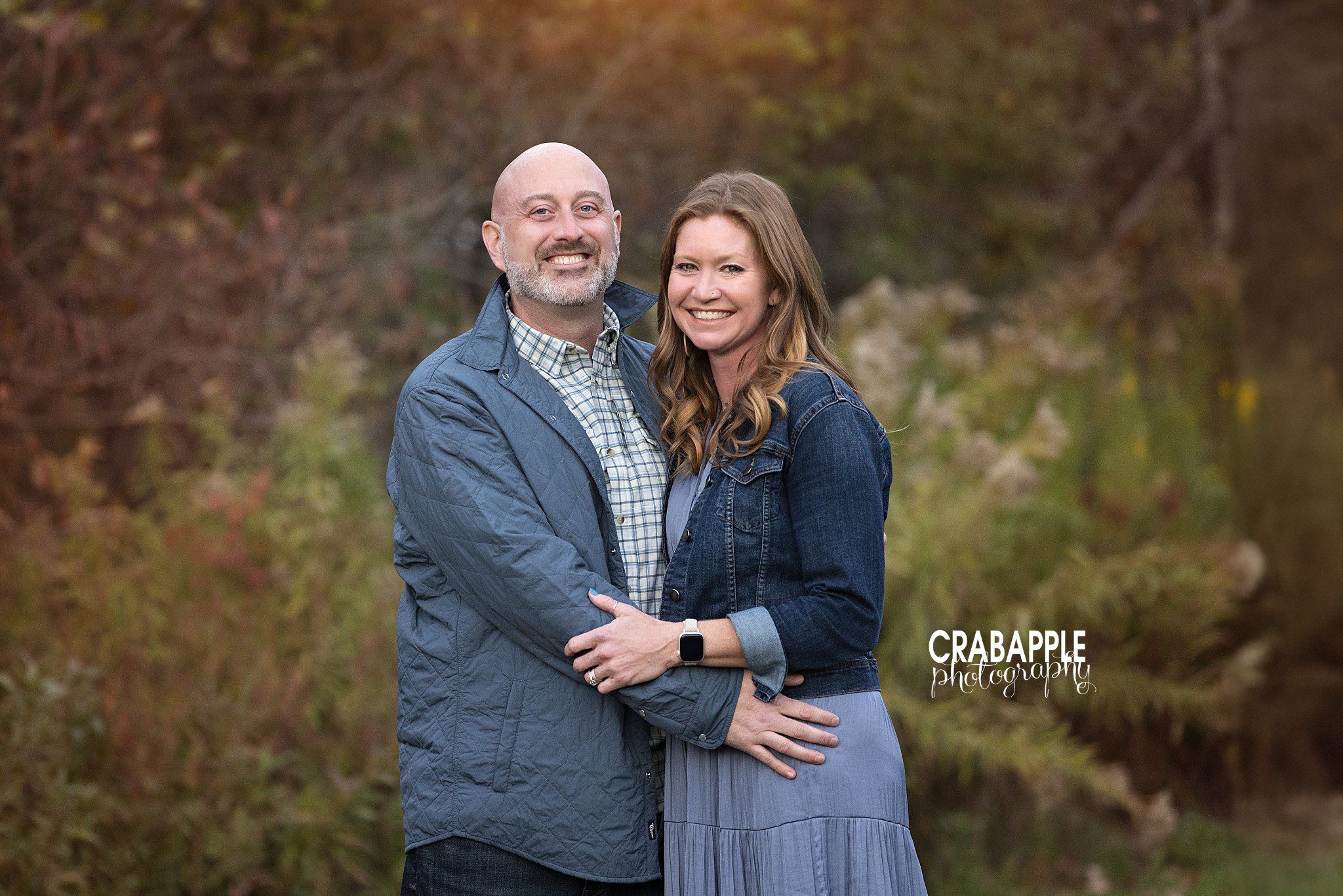 Mom and dad photographed together during their family's fall portrait session at Ipswich River Park
