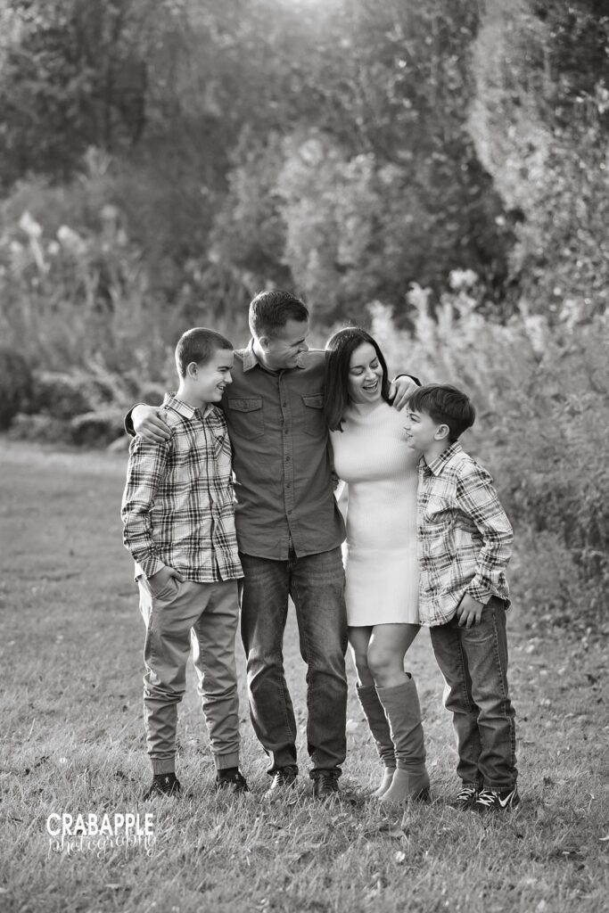 North Reading MA fall family photos Family posing together for fall family photos at Ipswich River Park in North Reading MA