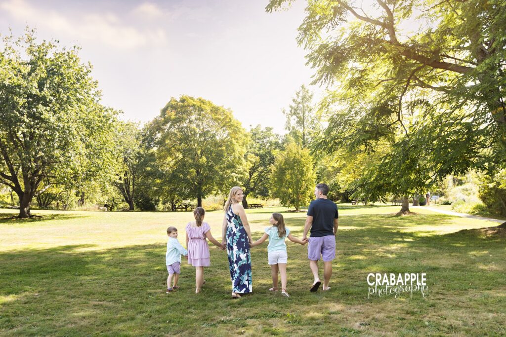 Family of five walking hand in hand during outdoor family photos in Acton MA
