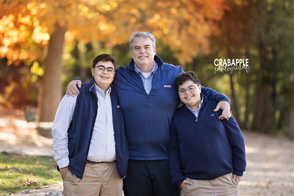 Boston area fall family photos Family enjoying a relaxed outdoor fall photography session in Medford MA