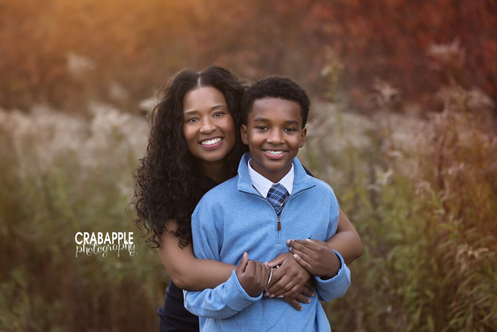 Mom and child fall family photos Mom cuddling her child during outdoor fall family photos at Ipswich River Park