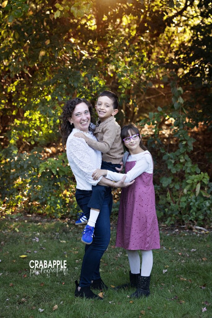 Mom and children fall family photos Mom with both children during an outdoor fall family photography session in Medford MA
