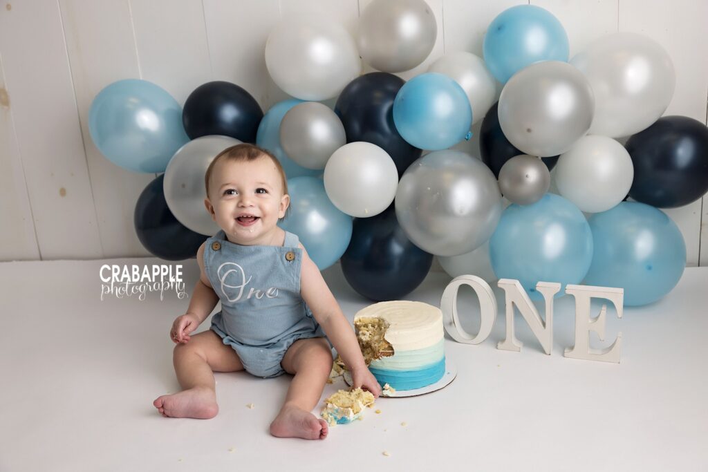 Baby boy enjoying his first birthday cake smash Baby boy enjoying a cake smash during his 1-year session in Andover MA