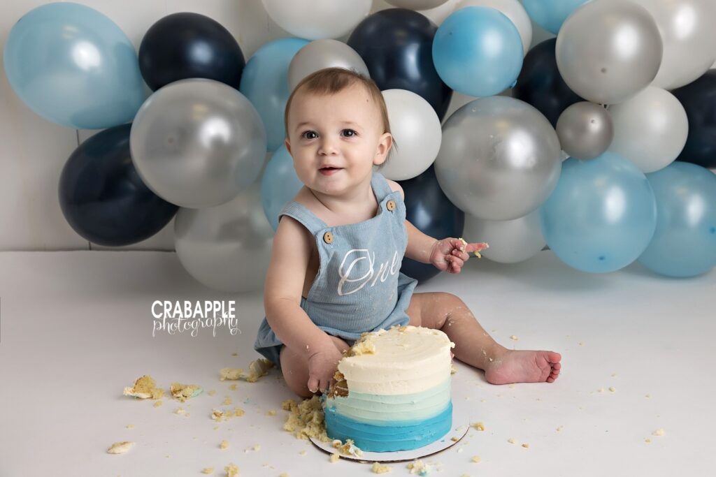 First birthday cake smash photos Baby boy during a first birthday cake smash session in Andover MA