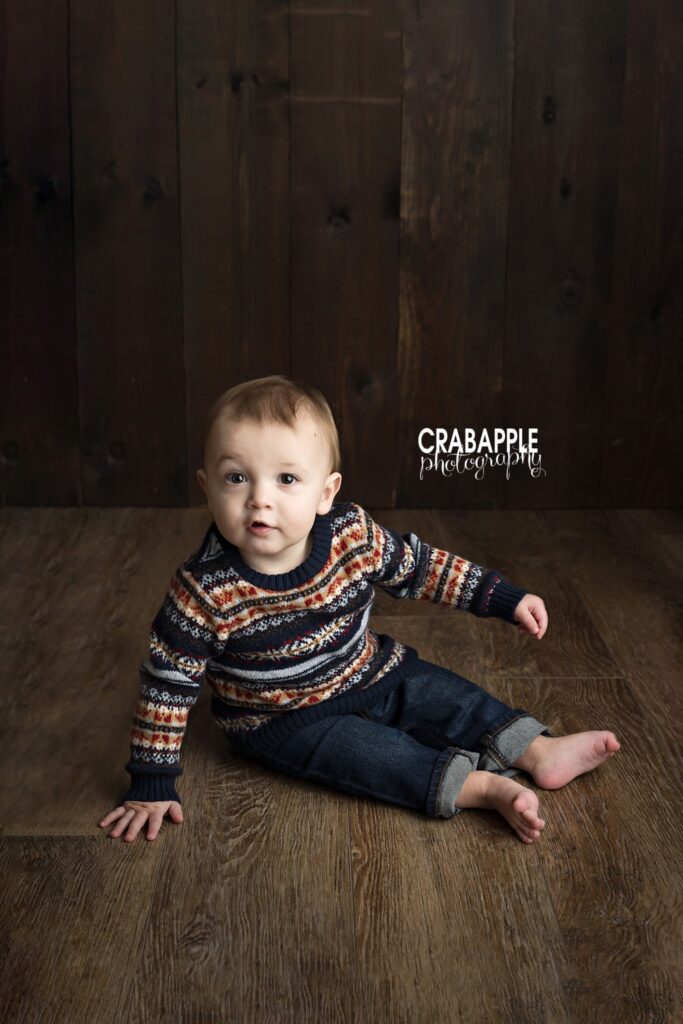 Baby boy in a striped sweater for his 1-year portraits Baby boy in a striped sweater during a 1-year photography session in Andover MA