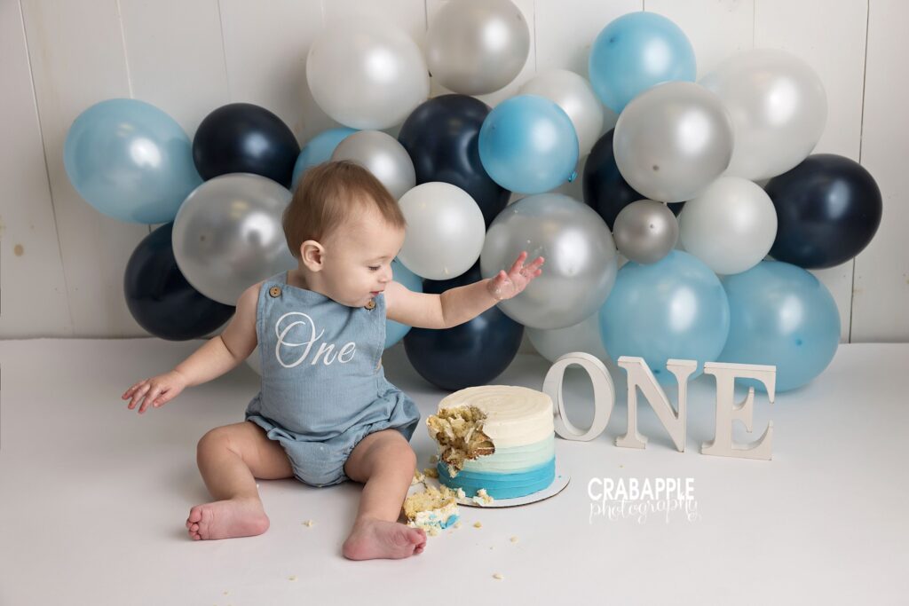 Baby boy cake smash session Baby boy enjoying a cake smash during his 1-year session in Andover MA