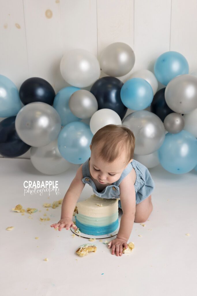 Baby crawling over his birthday cake Baby boy crawling over his birthday cake during a 1-year cake smash