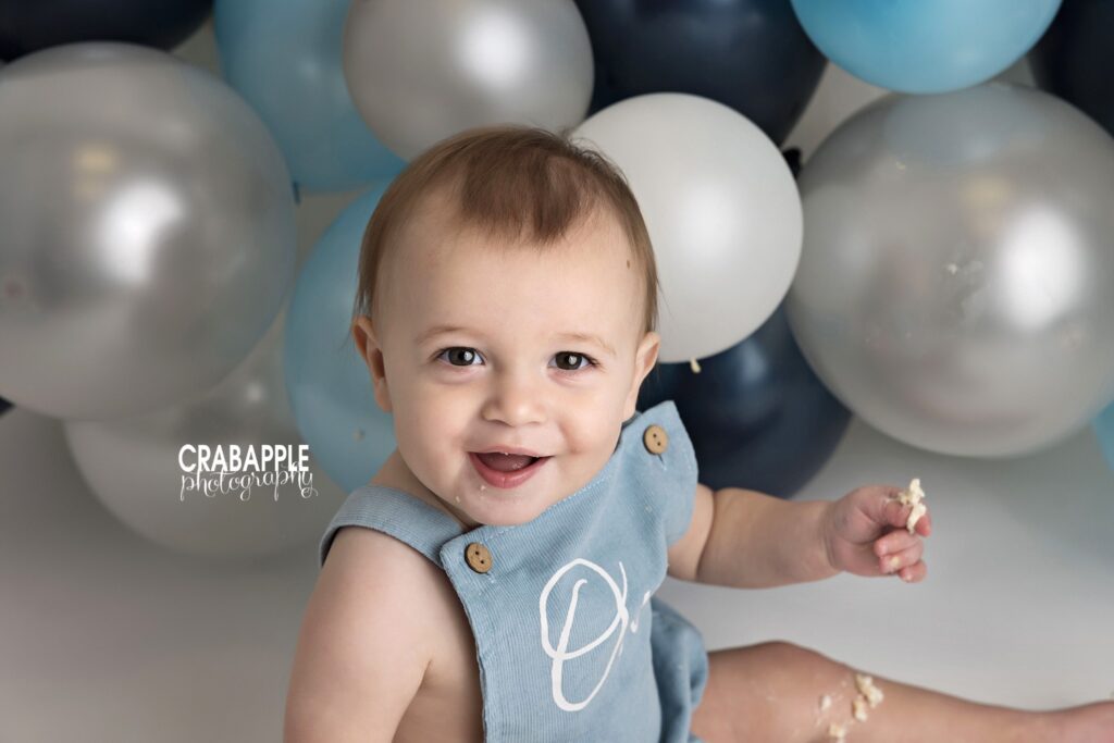 Close-up from a first birthday cake smash session Close-up portrait of baby boy enjoying his first birthday cake smash in Andover MA