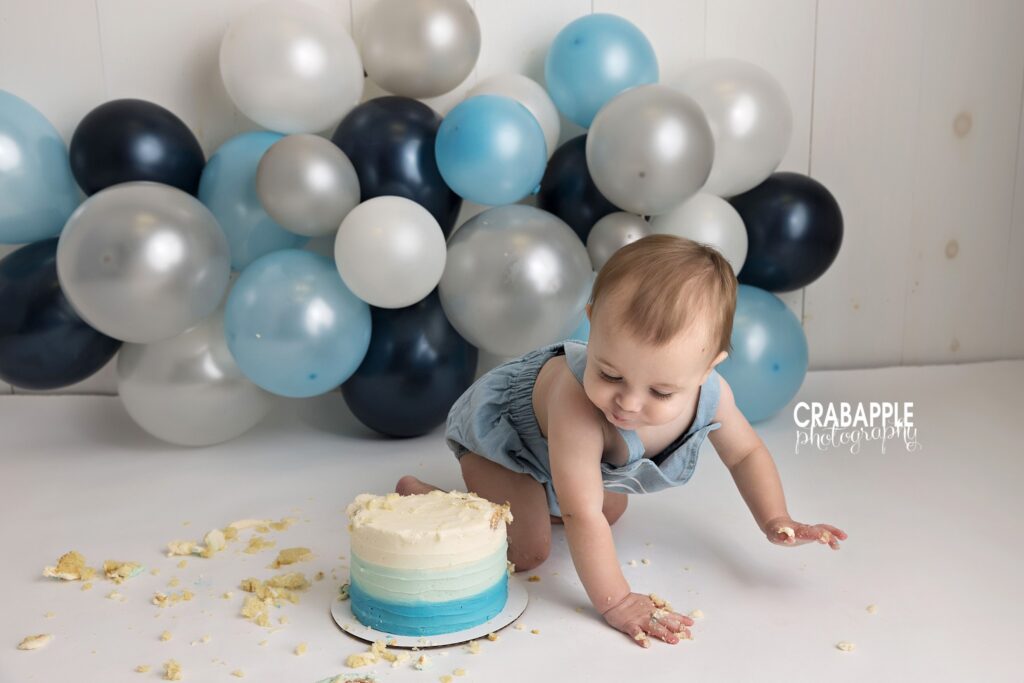 First birthday cake smash in Andover MA Baby boy celebrating his first birthday with a cake smash in Andover MA